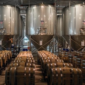 Group of craft brewery fermenters and oak barrels
